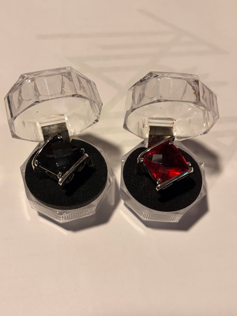 Red and black rings in silver tone setting